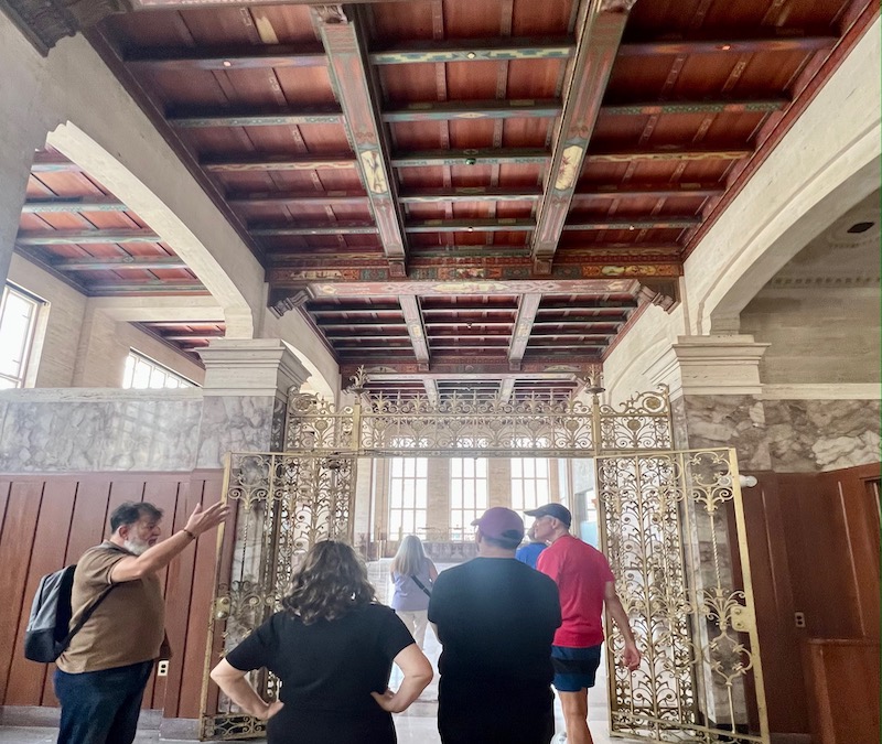 Small group walking tour visits historic Dupont building in downtown Miami.