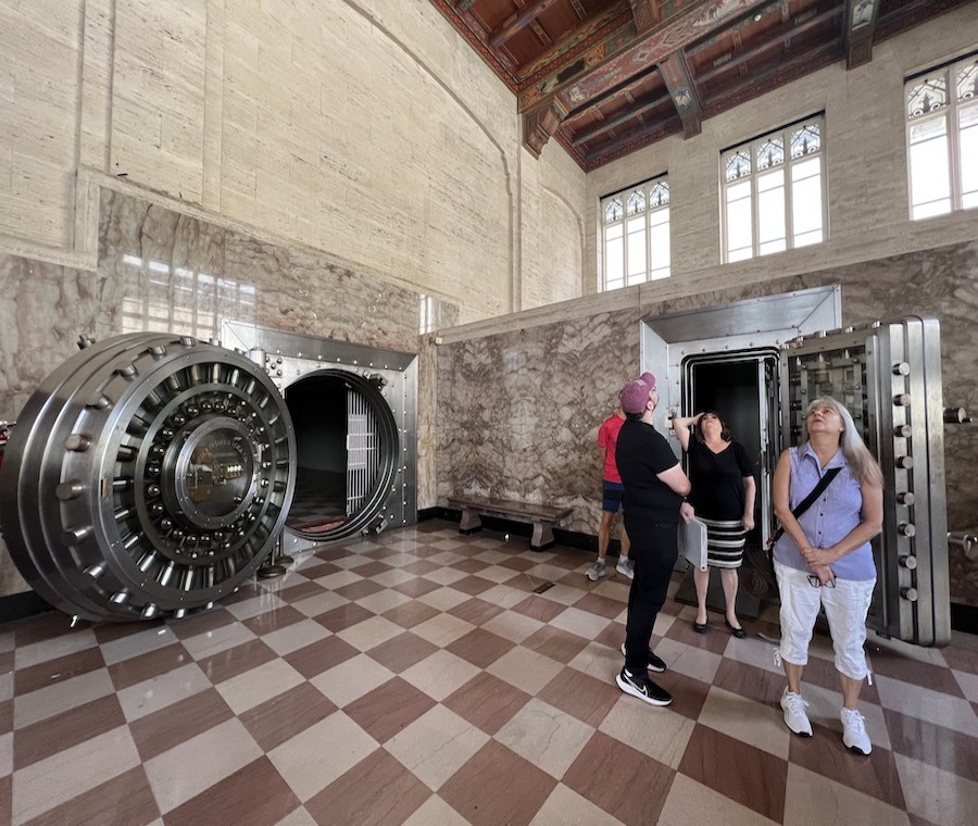Walking tour group visits historic vaults in Miami's Alfred I Dupont building.